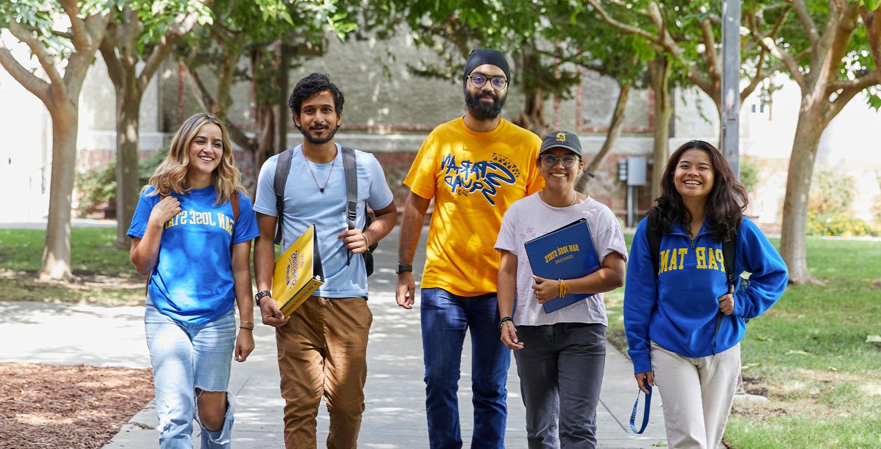 Students walking under trees